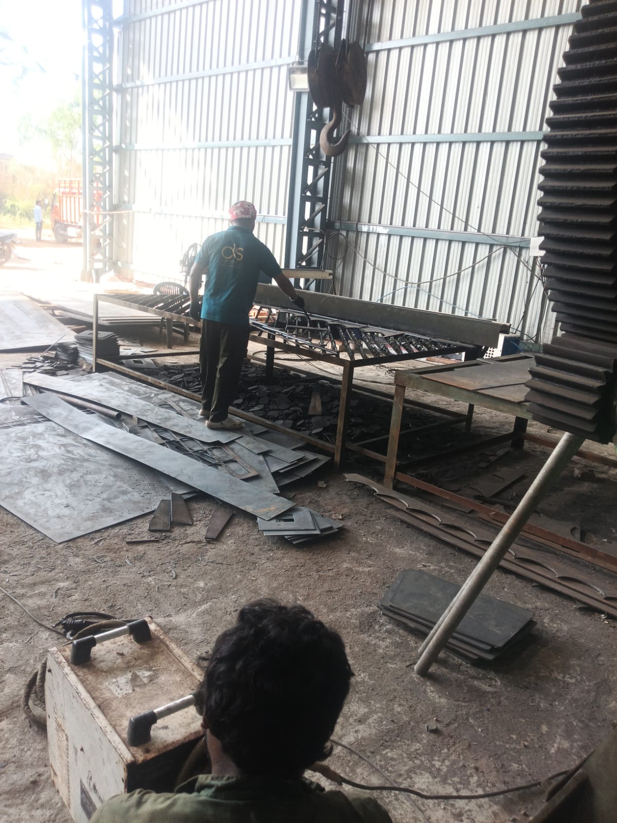 Steel fabrication operation in progress inside the workshop